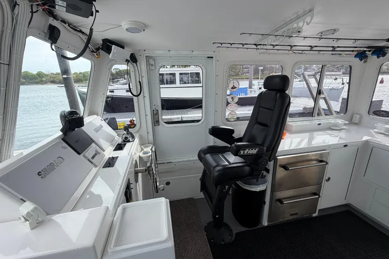 Slide: The Image of Interior of 2018 H&H Marine Osmond Beal boat with navigation equipment and captain's chair. - 30
