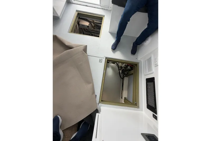 Slide: The Image of 2018 H&H Marine Osmond Beal interior with open hatch and visible engine compartment. - 27