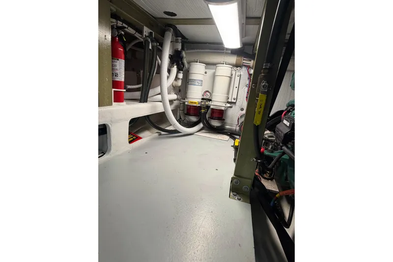 Slide: The Image of Engine room of 2018 H&H Marine Osmond Beal boat, featuring fire extinguisher and filtration system. - 63