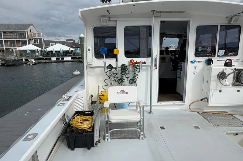 Slide: The Image of 2018 H&H Marine Osmond Beal boat deck with equipment and marina view. - 19