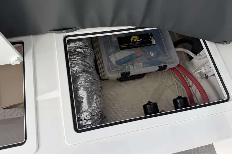 Slide: The Image of Storage compartment of 2018 H&H Marine Osmond Beal boat with tools and wiring. - 75