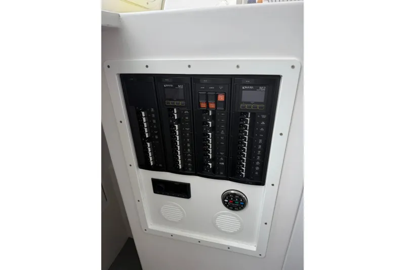 Slide: The Image of Electrical panel on a 2018 H&H Marine Osmond Beal boat, featuring circuit breakers and gauges. - 83