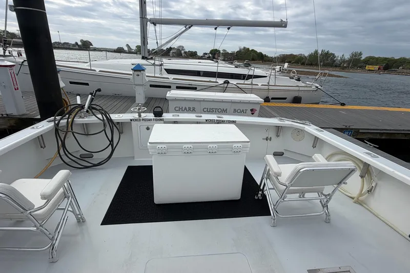 Slide: The Image of 2018 H&H Marine Osmond Beal boat docked, featuring spacious deck and seating. - 20
