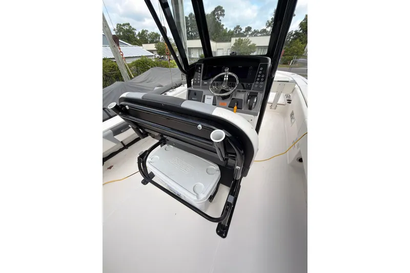 Slide: The Image of The image shows the cockpit of a 2022 Robalo 266 Cayman with a modern helm station. - 15