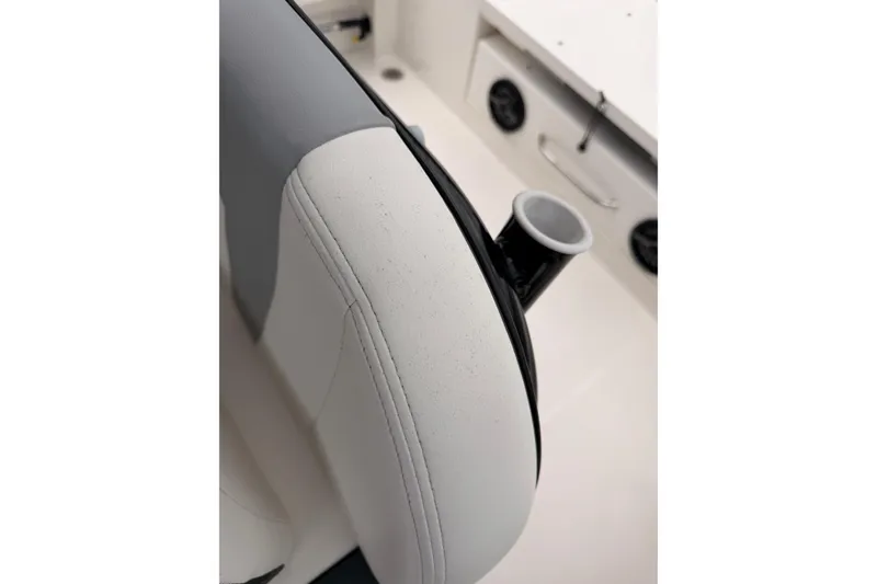 Slide: The Image of Close-up of a white boat seat with a black cup holder. - 37