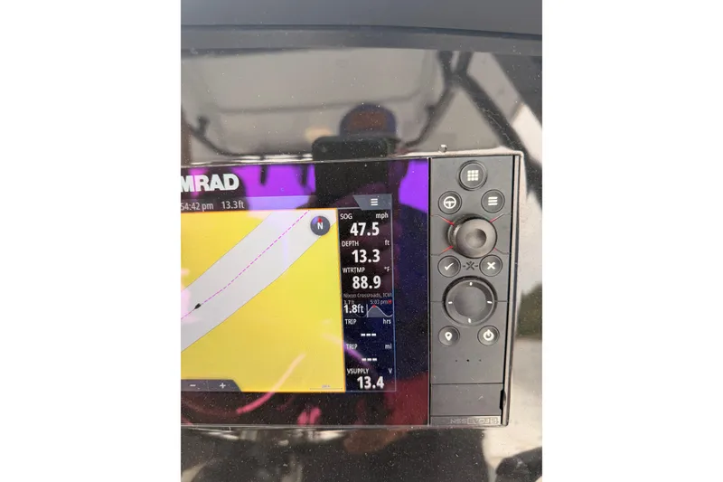 Slide: The Image of Simrad navigation display on 2022 Robalo 266 Cayman boat, showing speed and depth data. - 18