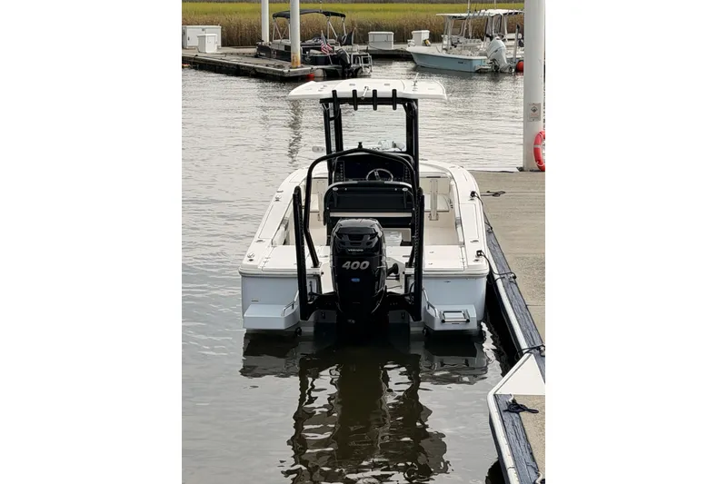 Slide: The Image of 2022 Robalo 266 Cayman boat docked with powerful 400 HP engine. - 13
