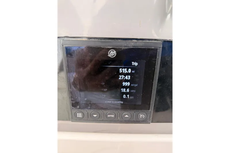 Slide: The Image of Display screen on 2022 Robalo 266 Cayman showing trip data and fuel efficiency. - 35