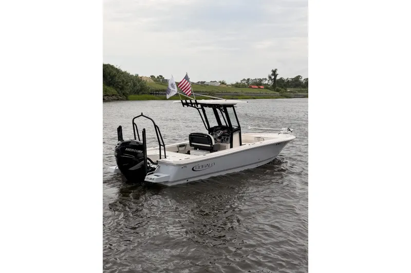 Slide: The Image of 2022 Robalo 266 Cayman boat on water, featuring Mercury engine and American flag. - 3