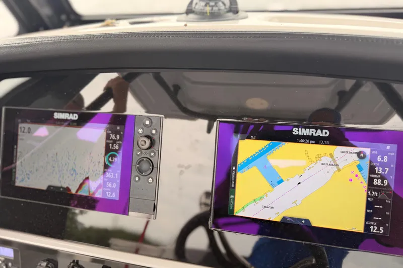 Slide: The Image of Simrad navigation displays on 2022 Robalo 266 Cayman boat dashboard. - 17