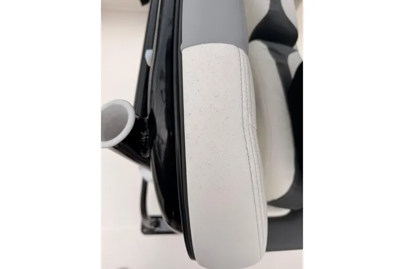 Slide: The Image of Close-up of a white seat with black trim on a boat. - 38
