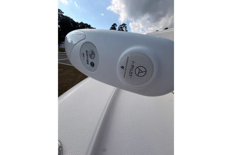 Slide: The Image of Close-up of Robalo 266 Cayman 2022 boat's i-Pilot system with Riptide branding. - 34