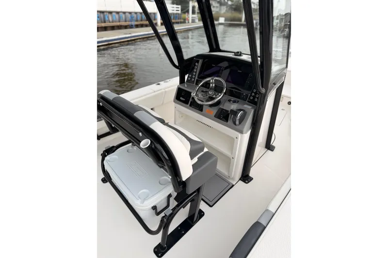 Slide: The Image of The image shows the cockpit of a 2022 Robalo 266 Cayman with a modern helm station. - 11