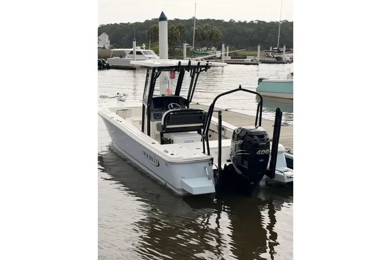 Slide: The Image of A 2022 Robalo 266 Cayman boat is docked in the water. It features a powerful outboard motor. - 14