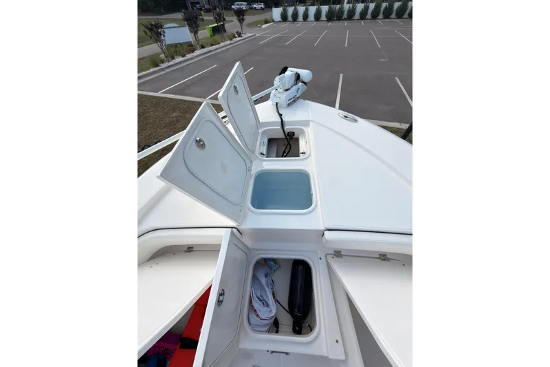Slide: The Image of 2022 Robalo 266 Cayman boat storage compartments open, showcasing spacious design. - 28