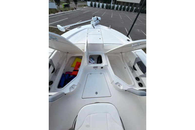 Slide: The Image of 2022 Robalo 266 Cayman boat deck with open storage compartments, showcasing spacious design. - 29