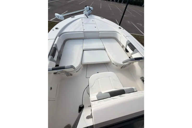 Slide: The Image of 2022 Robalo 266 Cayman boat interior with white seating and spacious deck layout. - 21