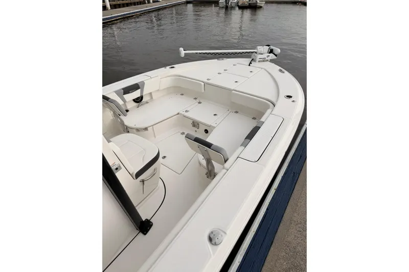 Slide: The Image of The image shows the deck of a 2022 Robalo 266 Cayman boat with white seating and storage. - 9
