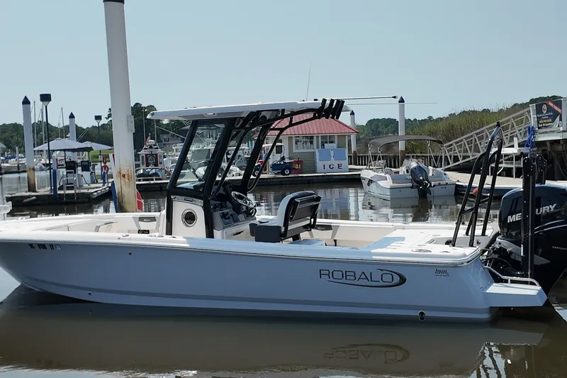 The Image of 2022 Robalo 266 Cayman boat docked at a marina with Mercury engine. - 1