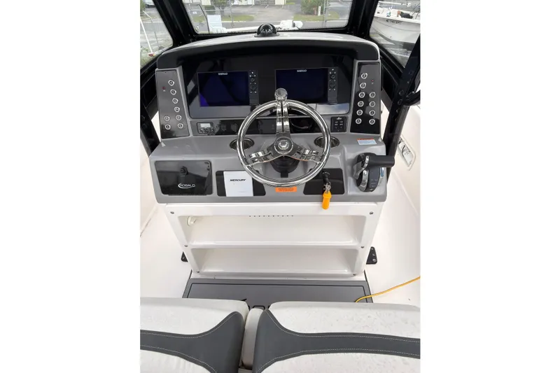 Slide: The Image of The image shows the helm of a 2022 Robalo 266 Cayman boat with modern instruments. - 16