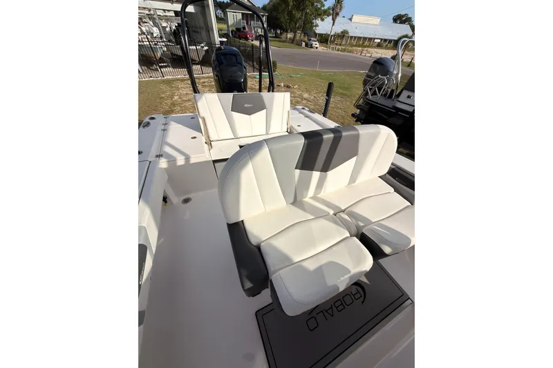 Slide: The Image of 2022 Robalo 266 Cayman boat interior with white seating and sleek design. - 23