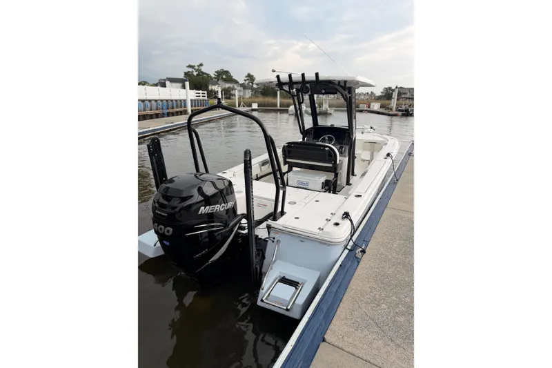 Slide: The Image of A 2022 Robalo 266 Cayman boat docked. It features a Mercury outboard motor. - 12
