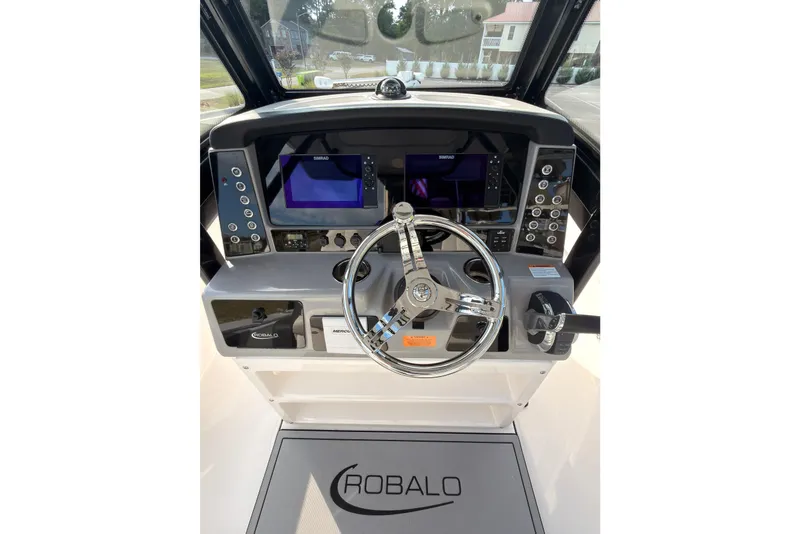 Slide: The Image of 2022 Robalo 266 Cayman boat helm with advanced controls and navigation displays. - 24