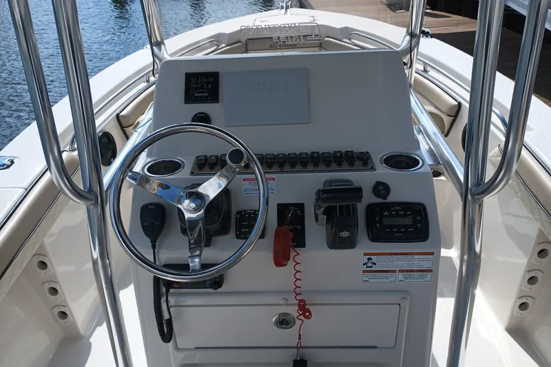 Slide: The Image of 2022 Sea Chaser 22 HFC boat console with steering wheel and controls. - 11