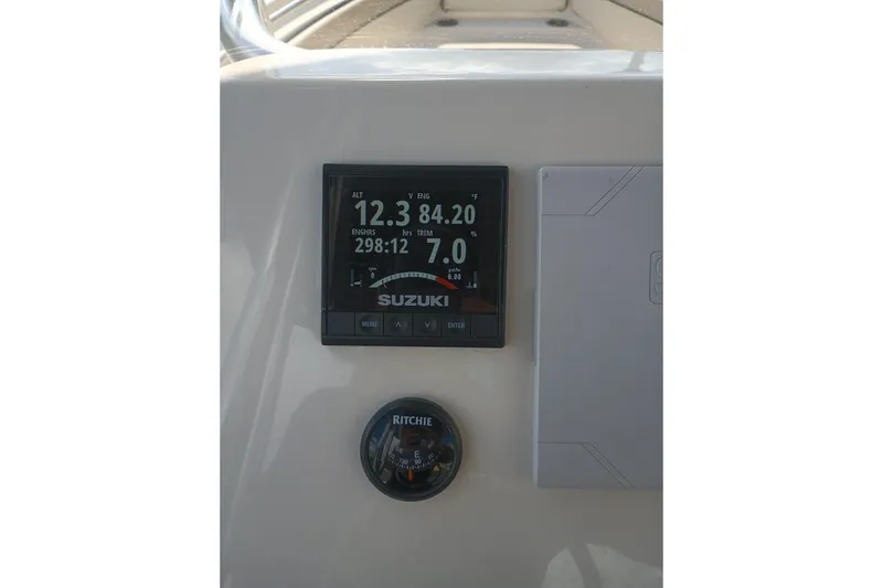 Slide: The Image of Dashboard of 2022 Sea Chaser 22 HFC boat with Suzuki display and Ritchie compass. - 13