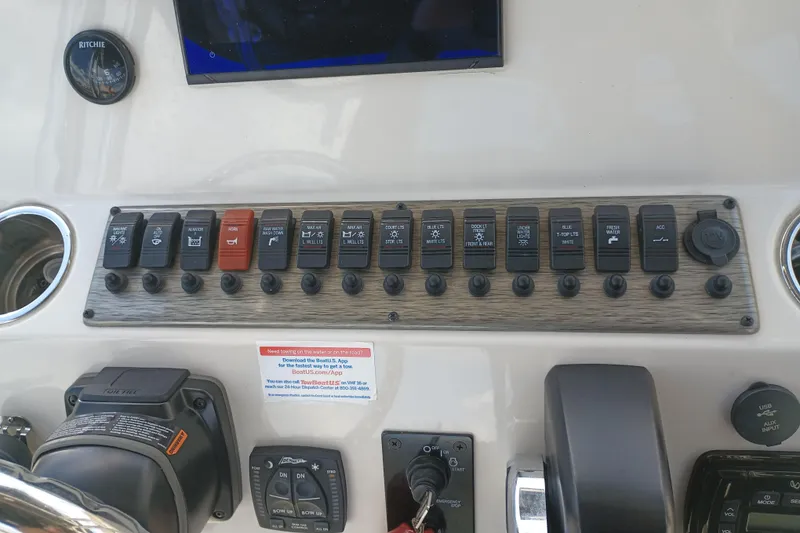 Slide: The Image of Control panel of a 2022 Sea Chaser 22 HFC boat with labeled switches. - 14