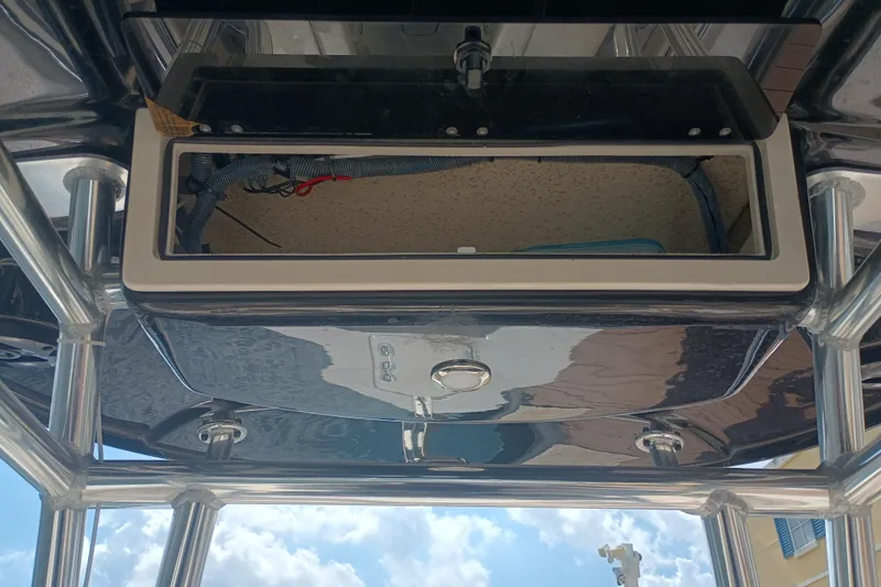 Slide: The Image of 2022 Sea Chaser 22 HFC boat console with open storage compartment under sunny sky. - 16