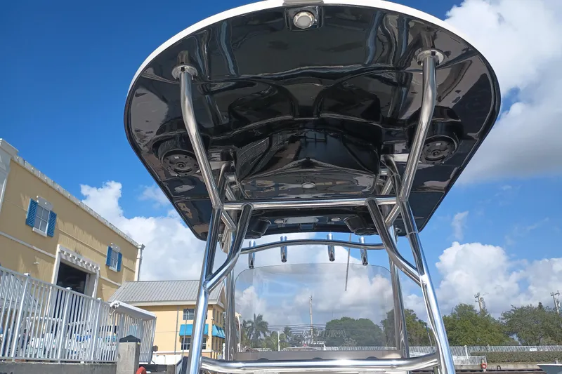 Slide: The Image of 2022 Sea Chaser 22 HFC boat with T-top against blue sky backdrop. - 17