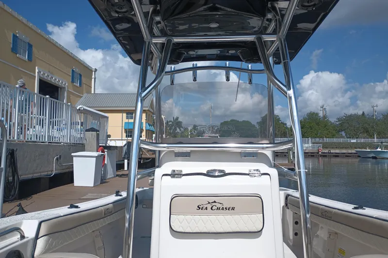 Slide: The Image of 2022 Sea Chaser 22 HFC boat docked at marina under clear blue sky. - 18