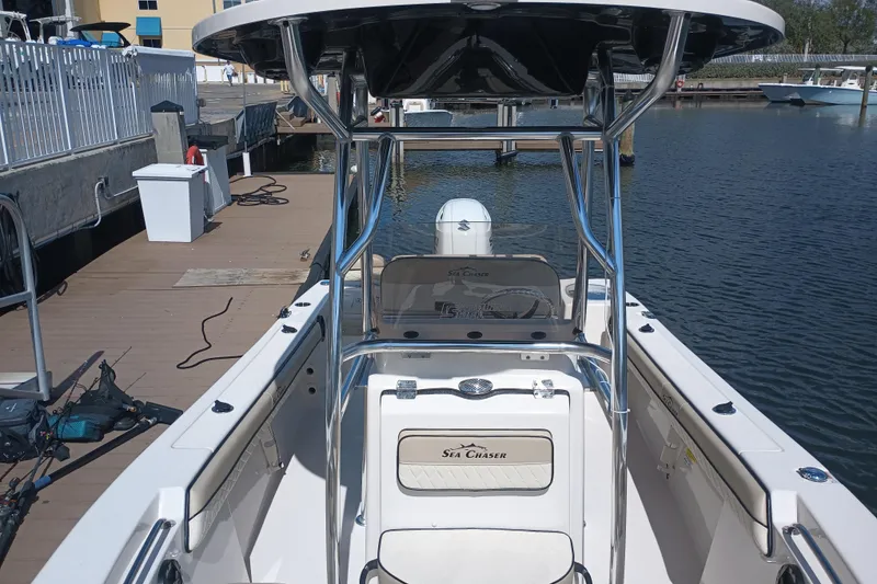 Slide: The Image of 2022 Sea Chaser 22 HFC boat docked at marina, featuring sleek design and modern amenities. - 22