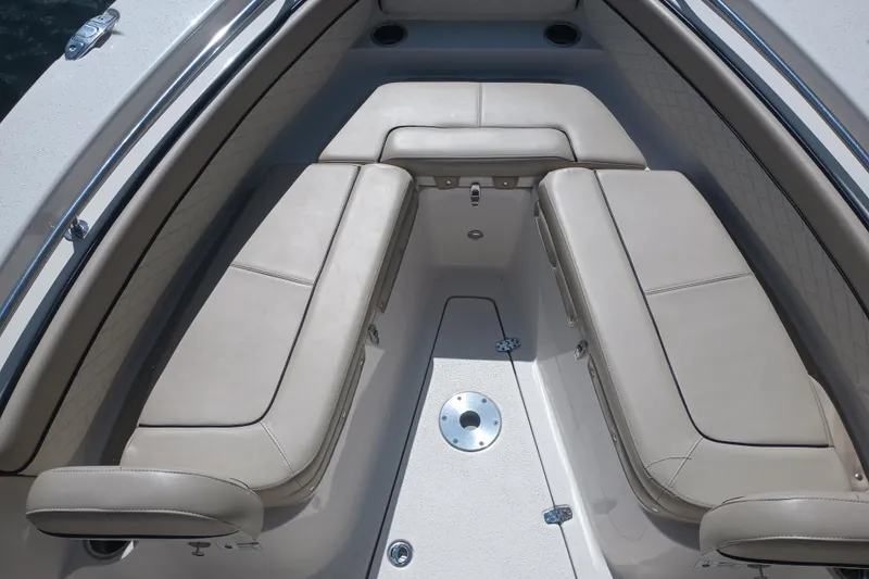 Slide: The Image of 2022 Sea Chaser 22 HFC boat interior with beige cushioned seating. - 23