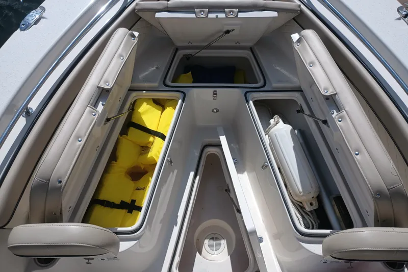 Slide: The Image of 2022 Sea Chaser 22 HFC boat storage compartments with life jackets and fenders. - 24