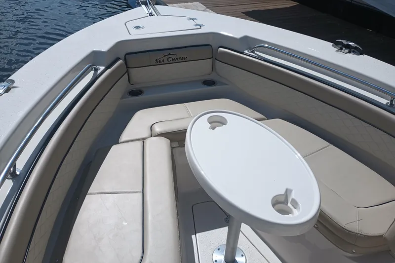 Slide: The Image of 2022 Sea Chaser 22 HFC boat interior with cushioned seating and table. - 26