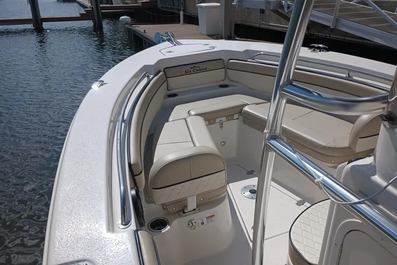 Slide: The Image of 2022 Sea Chaser 22 HFC boat interior with cushioned seating and stainless steel railings. - 28