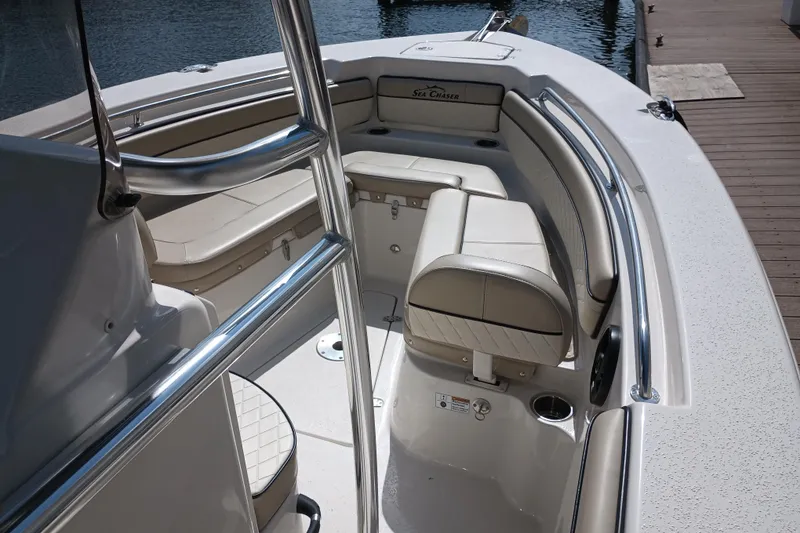Slide: The Image of 2022 Sea Chaser 22 HFC boat interior with beige seating and stainless steel rails. - 29