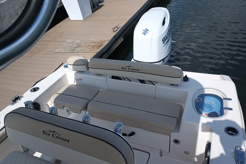 Slide: The Image of 2022 Sea Chaser 22 HFC boat interior with seating and Suzuki outboard motor. - 3