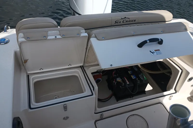 Slide: The Image of 2022 Sea Chaser 22 HFC boat interior showing storage compartments and battery setup. - 6