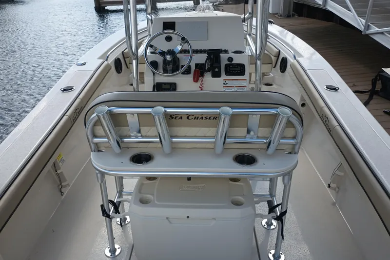 Slide: The Image of 2022 Sea Chaser 22 HFC boat interior with steering console and rod holders. - 8
