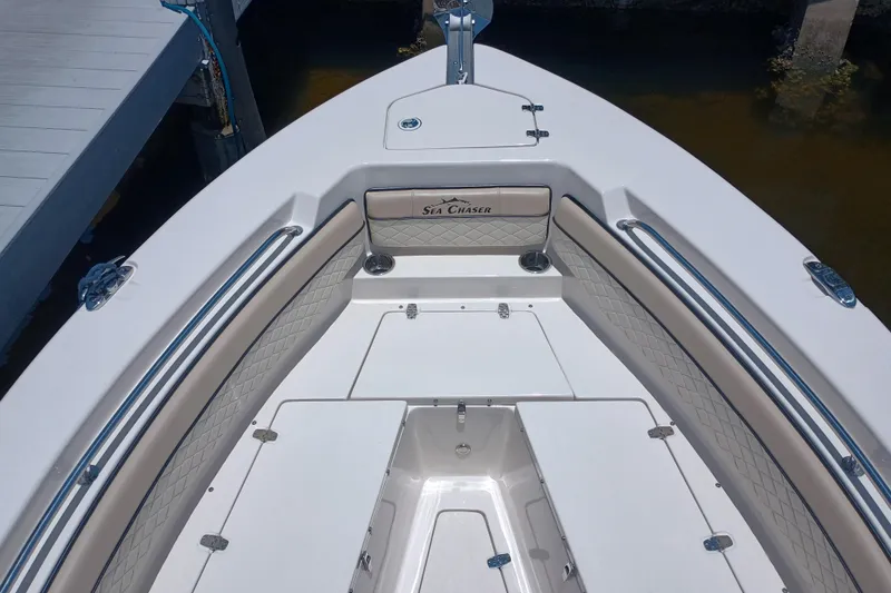 Slide: The Image of 2022 Sea Chaser 22 HFC boat interior with cushioned seating and storage compartments. - 39
