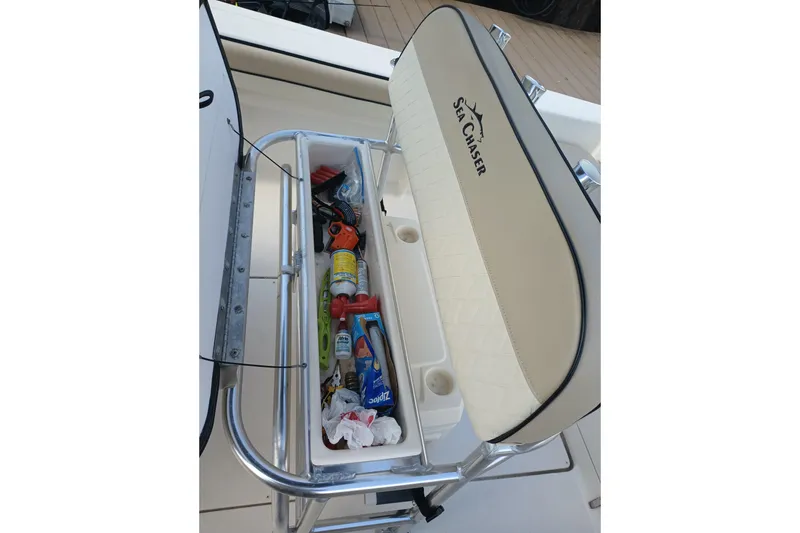 Slide: The Image of 2022 Sea Chaser 22 HFC boat storage compartment with various items inside. - 9