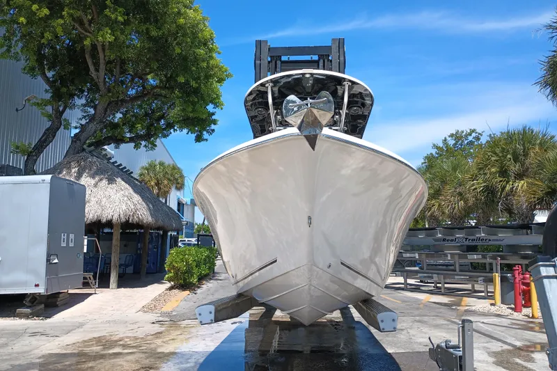 Slide: The Image of 2022 Sea Chaser 22 HFC boat on trailer, surrounded by trees and buildings. - 5