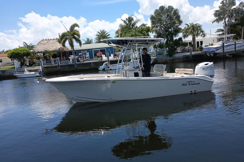 The Image of 2022 Sea Chaser 22 HFC boat on calm water near a tropical dock. - 0