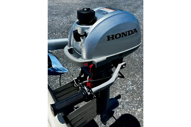 Slide: The Image of Honda outboard motor on 2018 American Sail 14.6 boat, parked on asphalt surface. - 11