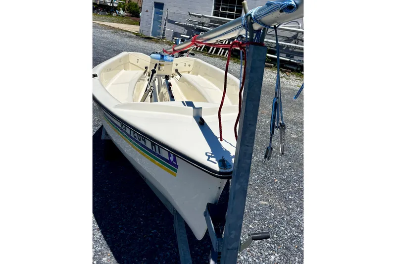 Slide: The Image of 2018 American Sail 14.6 sailboat on trailer, parked on gravel lot. - 5
