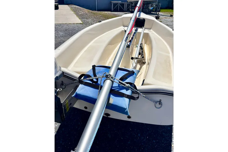 Slide: The Image of 2018 American Sail 14.6 boat interior with mast and blue cushion. - 6