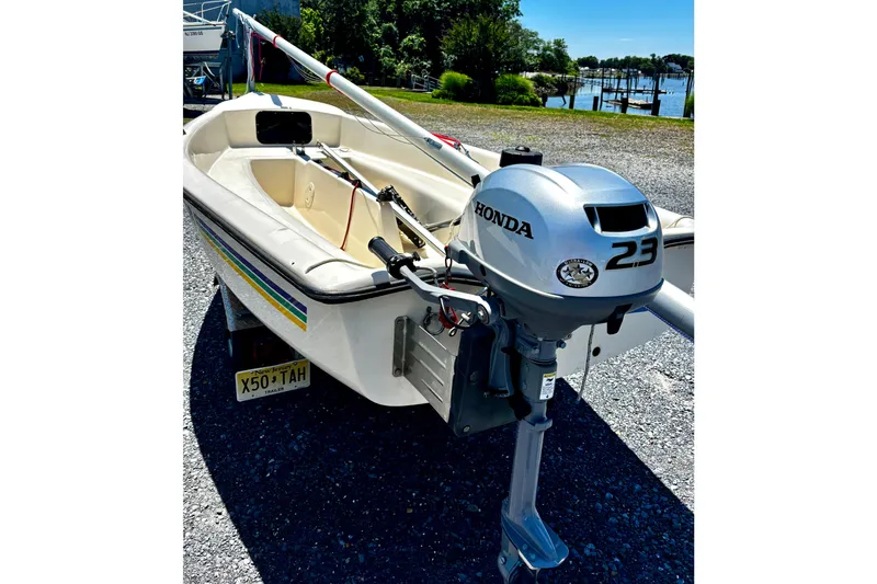Slide: The Image of 2018 American Sail 14.6 boat with Honda 2.3 outboard motor, parked near a waterfront. - 9
